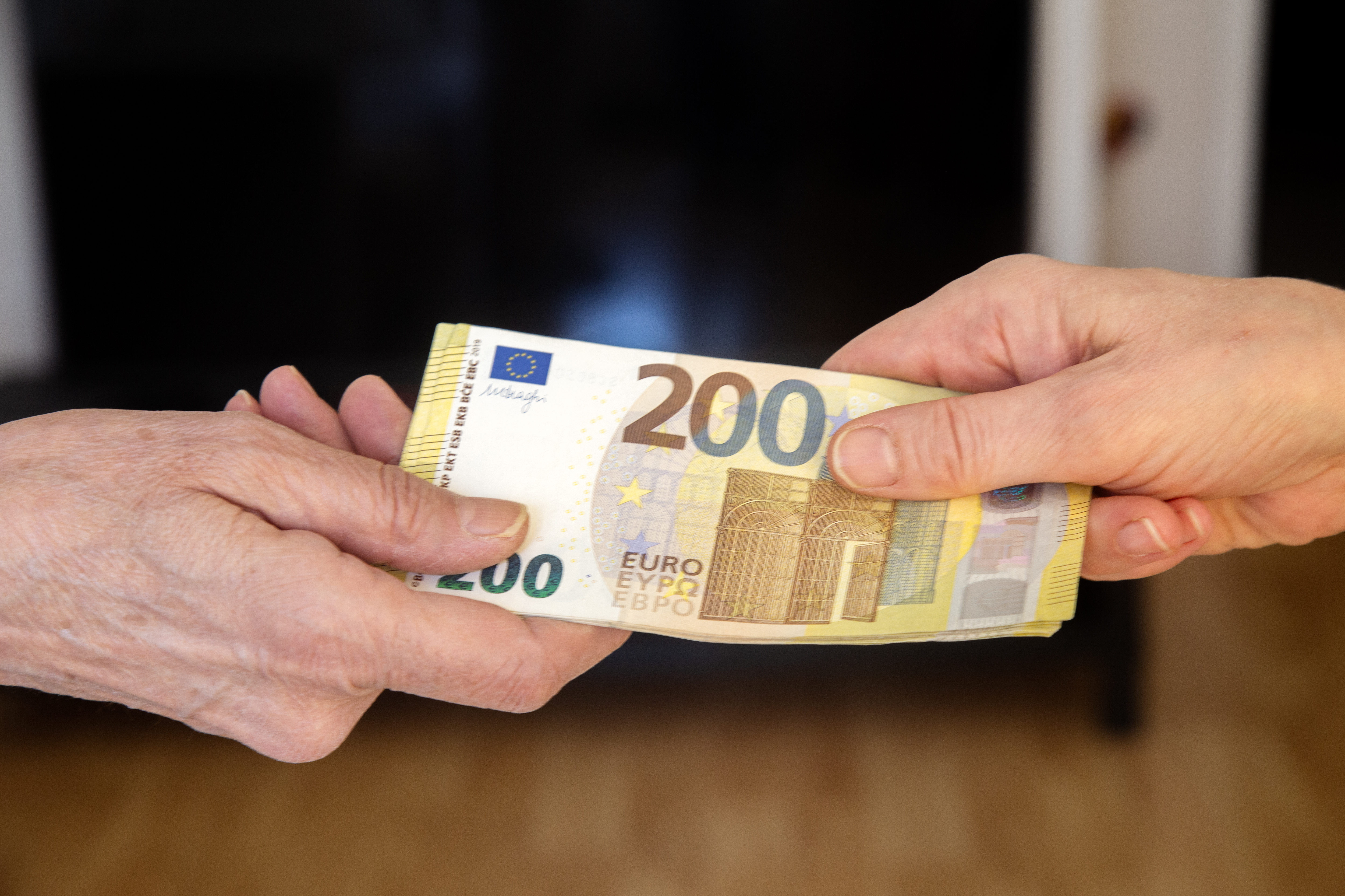 Businesswoman's hands exchanging euro banknotes